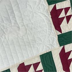 20th century quilt, with repetitive ship design to the centre within a cream red and green...