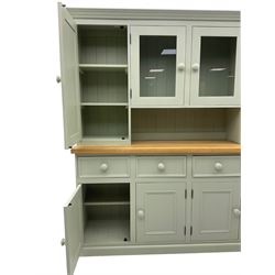 Painted kitchen dresser, projecting moulded cornice over central glazed display doors and flanking panelled cupboard doors, polished oak rectangular top over four drawers and four cupboards, on moulded plinth base, in laurel green paint finish 