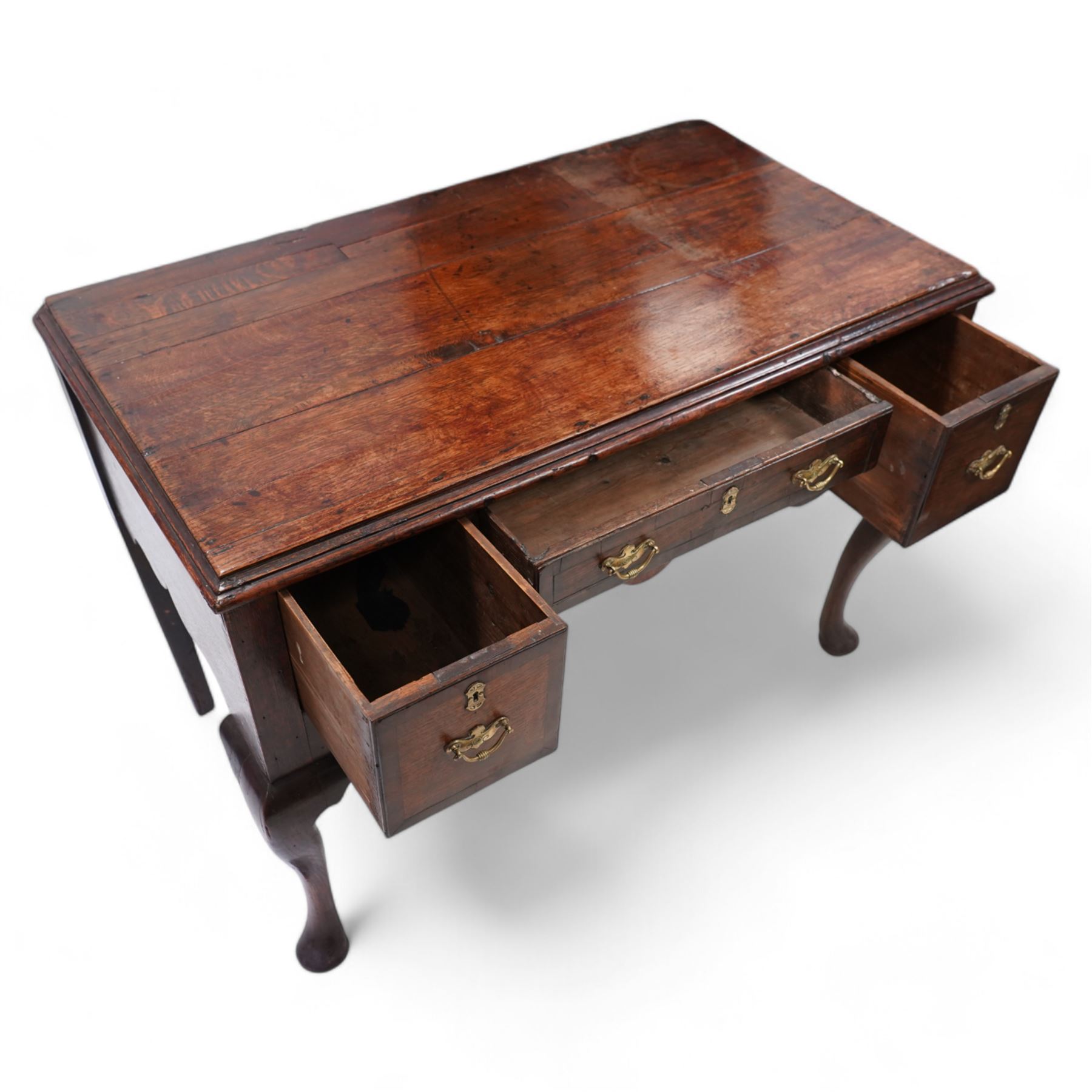 18th century oak low-boy, moulded rectangular top over three drawers and shaped apron, the mahogany banded drawer fronts fitted with shaped brass handles, on cabriole front supports and square tapering rear supports 