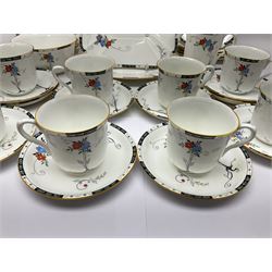 Art deco Shelley tea service for eight, decorated with floral sprigs, comprising teacup and saucers, dessert plates, two cake plates, milk jug and open sucrier, with to extra dessert plates