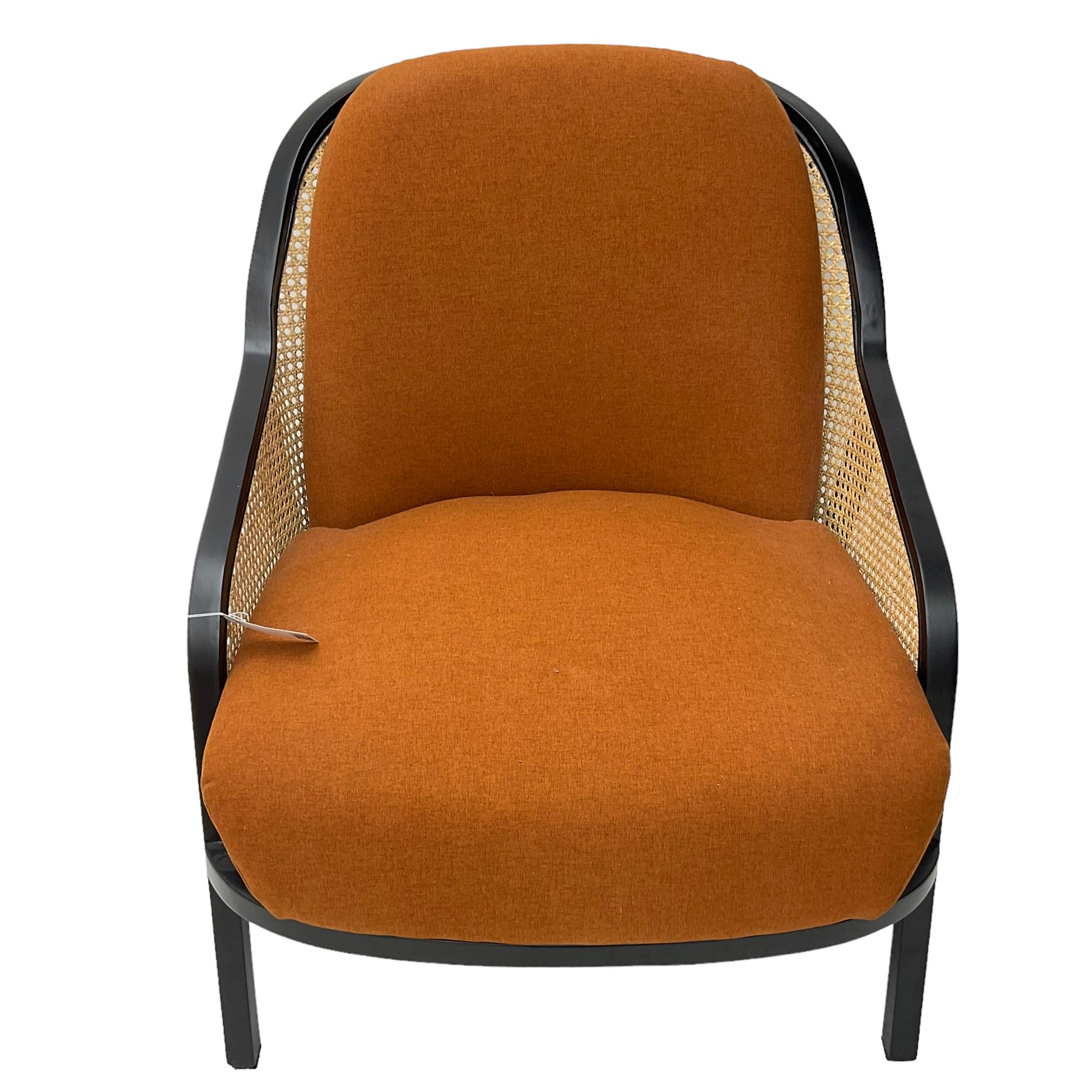 Contemporary MADE Anakie armchair, black lacquered frame with cane backrest, orange fabric upholstered seat and back cushion, sloped armrests, on splayed supports