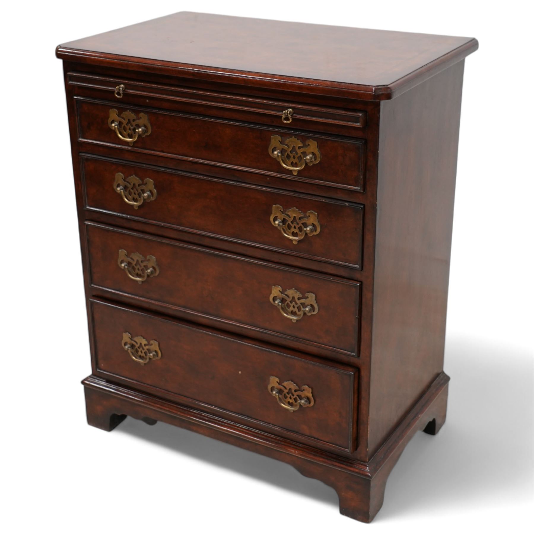 Small Georgian design walnut chest, rectangular moulded top with crossbanding and feather bands, shaped canted corners, slide over four graduating cock-beaded drawers, pierced brass handle plates, on bracket feet 