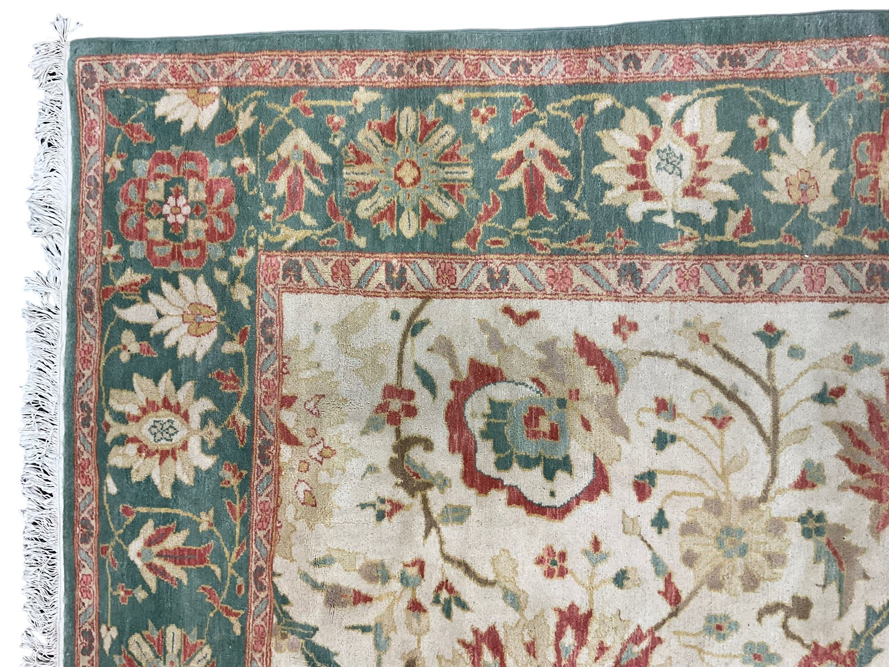 Persian Ziegler design carpet, pale ground field decorated with large stylised plant motifs, the border decorated with large floral motifs within repeating guards