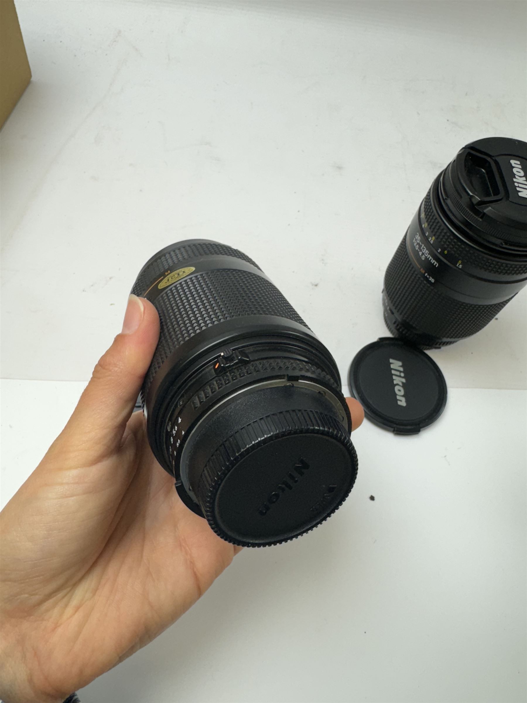 Four Nikon camera lenses, to include AF Nikkor 70-210mm 1:4-5.6 serial no. 2000640, AF Nikkor 70-300mm 1:4-5.6 G serial no. 2284940, AF Nikkor 35-135mm 1:3.5-4.5 serial no 301027 and AF Nikkor 28-100mm 1:3.5-5.6 G serial no 2185570