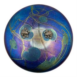 John Ditchfield for Glasform disc paperweight in iridescent purple with green lily trail a...