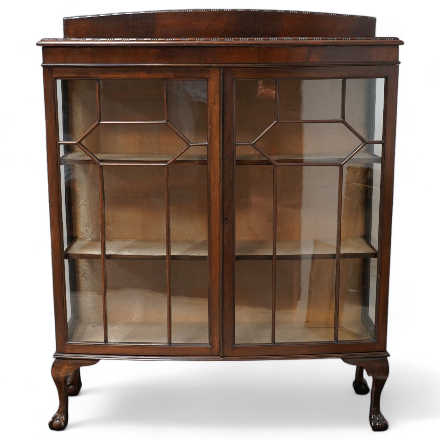 Early 20th century mahogany bow-front display cabinet, fitted with two astragal glazed doors enclosing two shelves, on cabriole supports with ball and claw feet