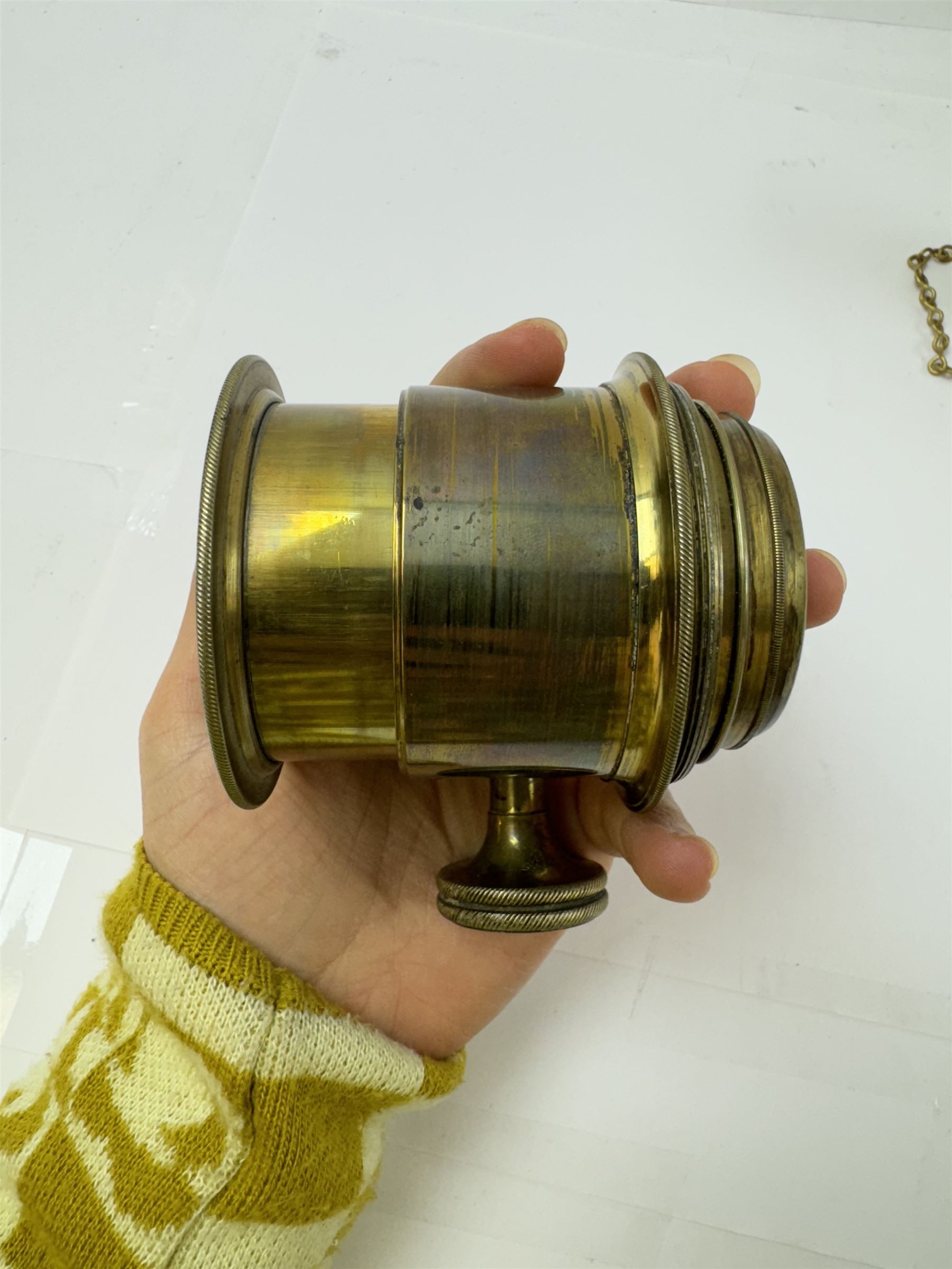 Late 19th century Watkins Exposure Meter, in cylindrical brass case, inscribed Sole Makers R. Field & Co, Birmingham, together with a 19th century brass plate camera lens