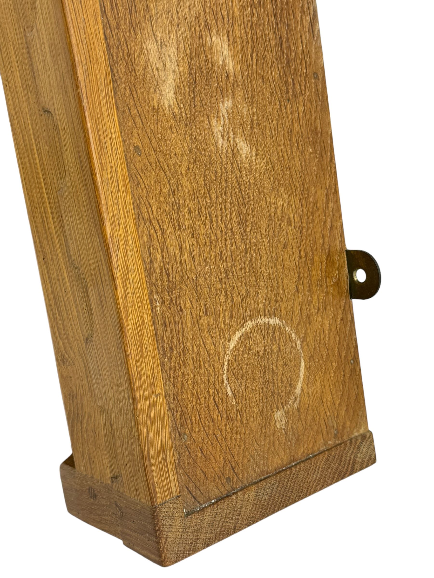 Rabbitman - oak wall hanging plate rack, moulded cresting rail over two shelves, shaped end supports, carved with rabbit signature, by Peter Heap, Wetwang