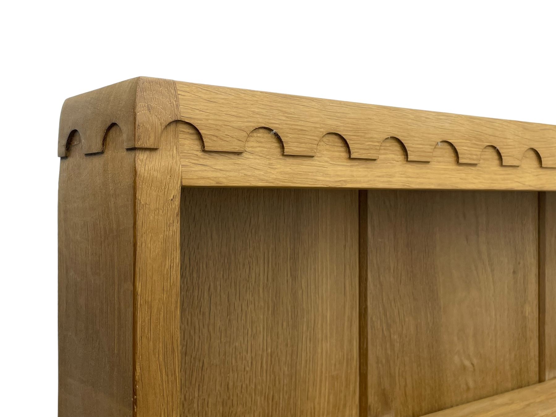 Mouseman - oak dresser, penny moulded cresting rail over two shelves supported by shaped ends, canted rectangular adzed top, fitted with two drawers and panelled cupboards, with wrought iron hinges and catches, on octagonal feet, carved with mouse signature, by the workshop of Robert Thompson, Kilburn 