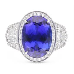 Platinum tanzanite and diamond ring, oval cut tanzanite, with round brilliant cut diamond surround, each side flanked by a single bullet cut diamond, with round brilliant cut diamond surround, hallmarked, tanzanite 9.16 carat, bullet cut diamonds 0.95 carat, round brilliant cut diamonds 0.83 carat