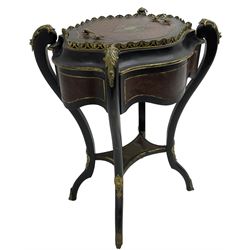 Late Victorian ebonised and amboyna wood jardinière planter, shaped form with removable lid inlaid with scrolling brass work and mounted by ornate cast gilt metal handles, the frieze rails inlaid with amboyna panels and brass stringing, on cabriole supports united by under-tier, decorated with cast gilt metal acanthus leaves and hooved feet caps