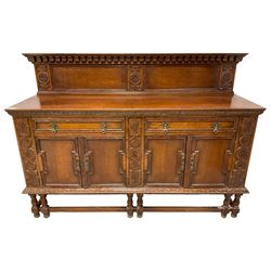 Early 20th century oak sideboard, raised panelled back with foliate carved decoration, rectangular top with gadrooned edge, fitted with two drawers over cupboards with field moulded facias, turned supports joined by stretchers