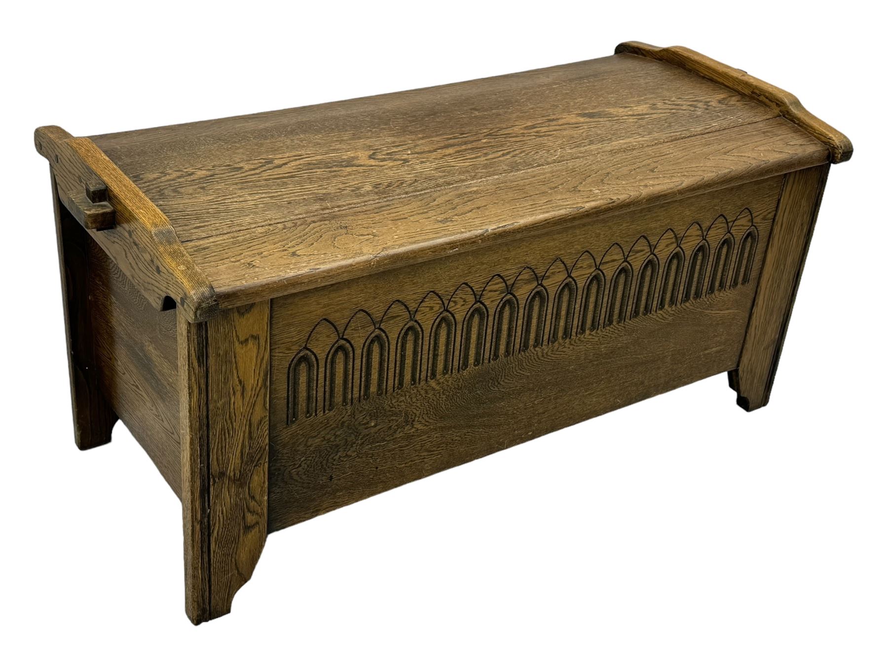 20th century oak coffer or blanket chest, rectangular hinged top over repeating Gothic arch carved front and shaped sides, constructed with pegged joints, on stile supports