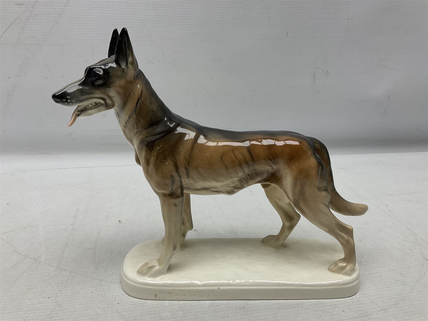 Two Hertwig and Co Katzhutte figures of dogs, comprising a German Shepherd and a pointer dog, both with printed marks beneath, largest H21.5cm W25cm