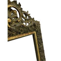 Victorian giltwood and gesso wall mirror, pierced shell cartouche pediment decorated with C-scrolls and curled leaves, moulded frame with curled acanthus leaf decoration and beaded inner slip, the corner brackets decorated with flower heads 