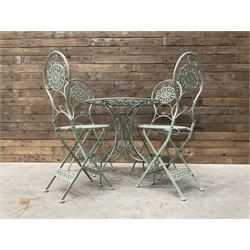 Circular wrought metal green painted circular garden table, and four folding chairs