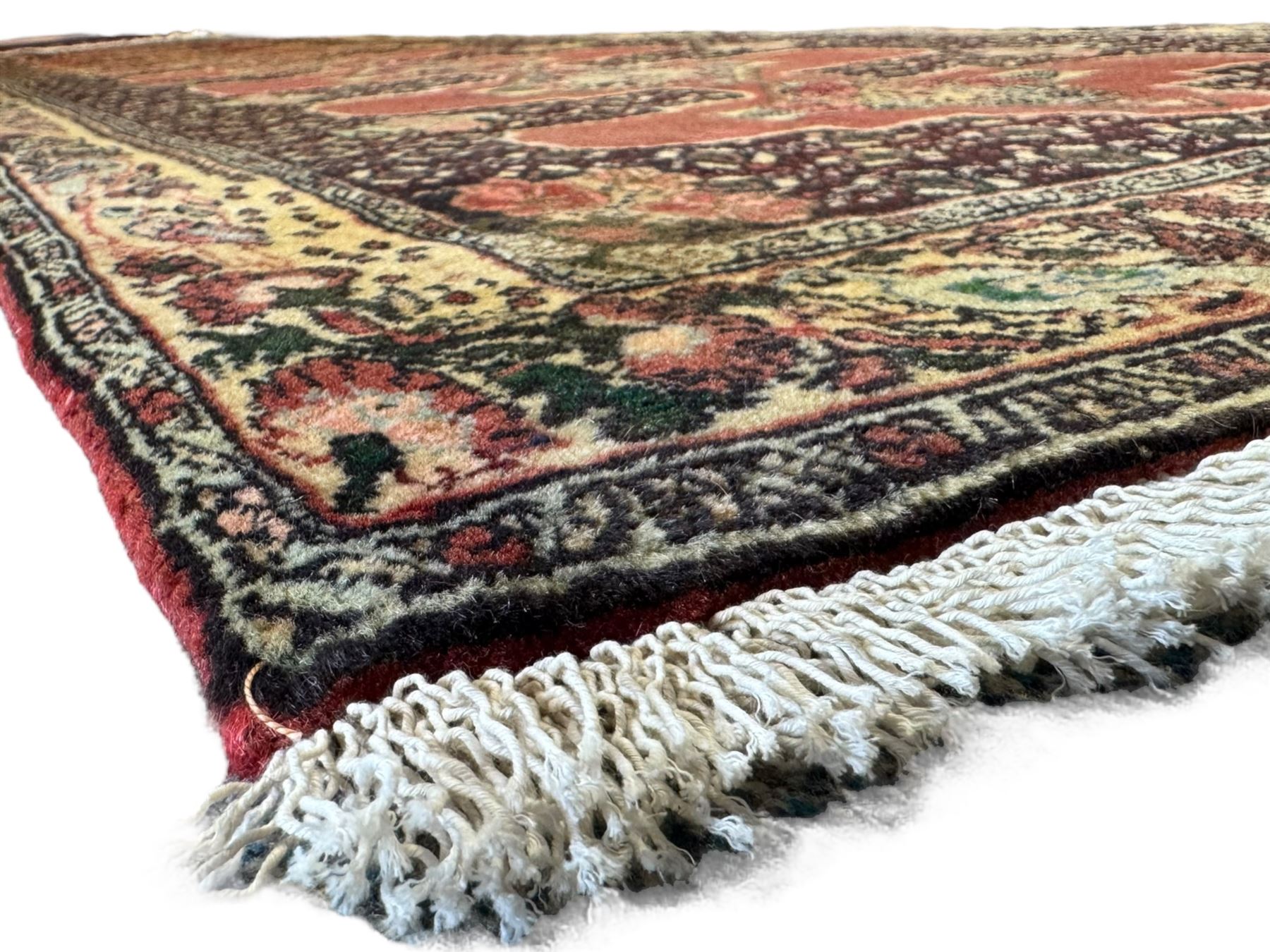 Kurdish rose ground runner rug, set with a series of ten floral medallions on linked field, the border decorated with stylised flower heads and bird motifs 