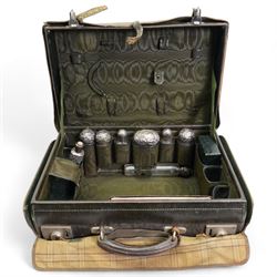 Edwardian ladies leather travelling dressing case by Army & Navy Co-operative Society, the watered silk interior with silver mounted glass bottles, leather jewellery box, leather folding stationery case and inkwell etc the silver hallmarked for London 1901 Maker Frederick Bradford Macrae 47cm x 33cm with outer canvas case