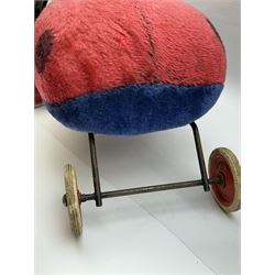 Steiff child's ride on ladybird, circa 1950s, the mohair body with red and black spotted seat, black and white face and blue underbelly, upon a metal frame with rubber and metal wheels, H30cm, W52cm