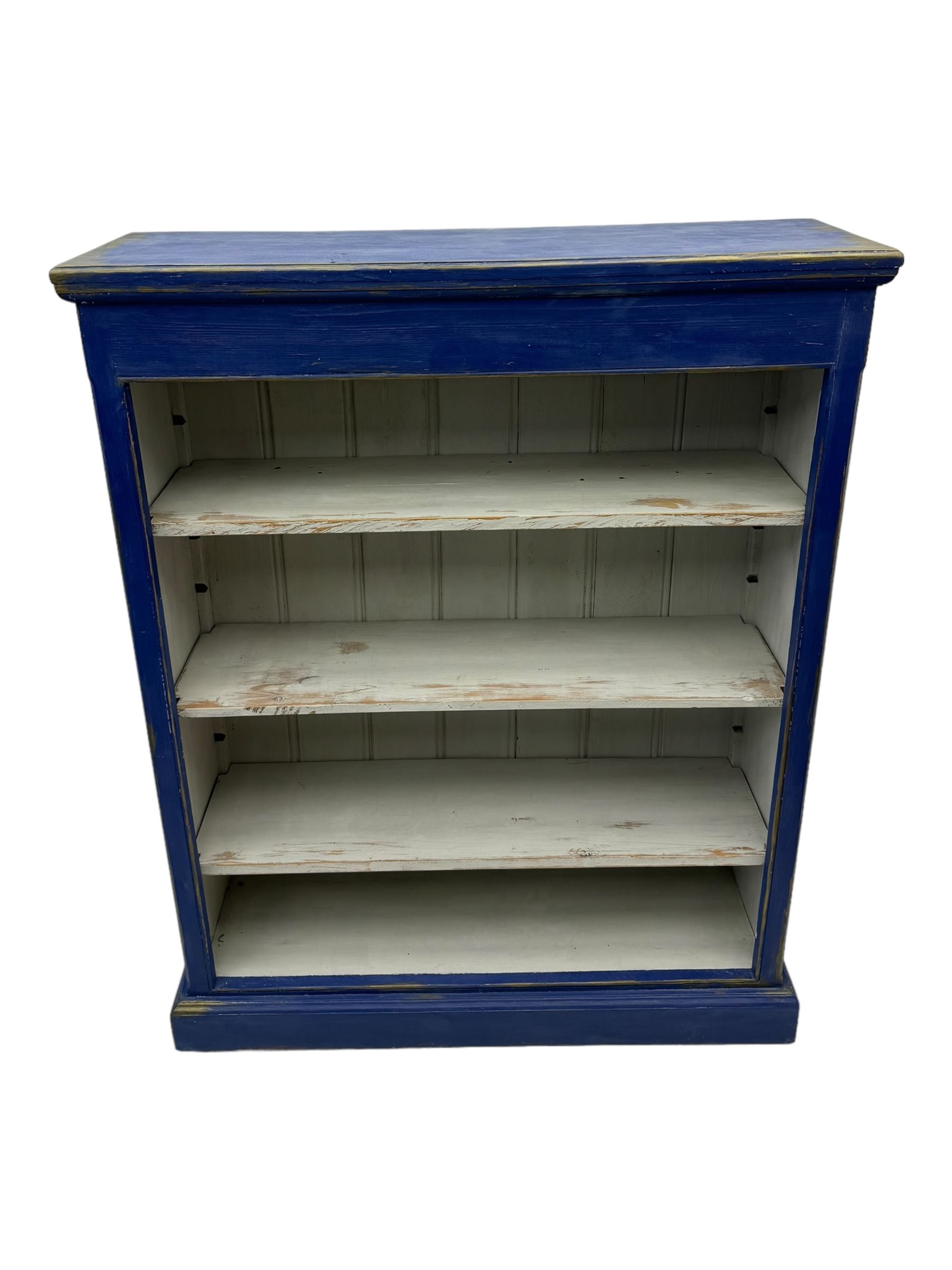 Pine blue painted open bookcase, moulded rectangular top over three white painted adjustable shelves, on plinth base