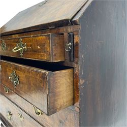 George I figured walnut bureau, hinged fall front enclosing drawers, pigeon holes and slide revealing storage well, fitted with four long cock-beaded and graduating drawers, shaped brass handle plates and escutcheons, on turned bun feet 