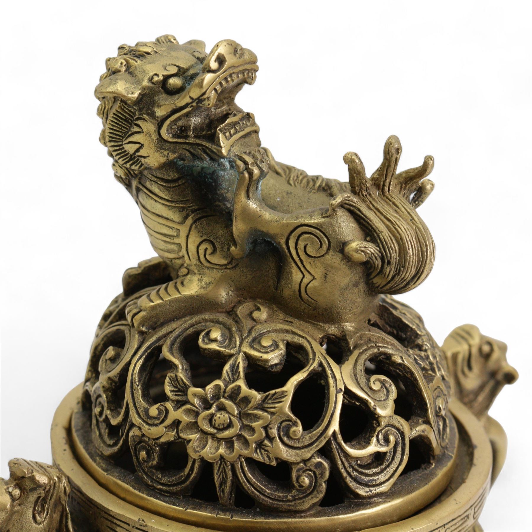 Chinese polished bronze incense burner and cover, pierced domed cover with temple lion finial, the base cast with scrolling foliage on tripod temple lion mask legs, Xuande seal mark, H18cm 