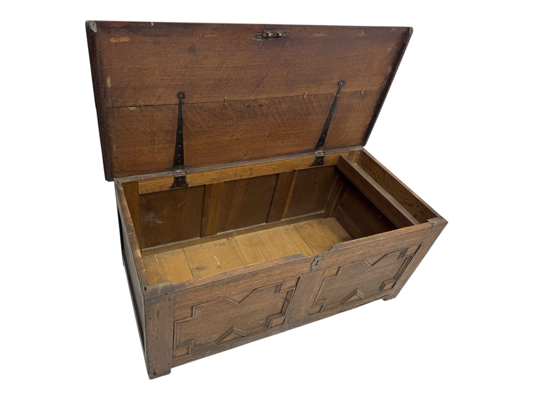 18th century oak blanket box, rectangular form with a hinged lid, the front decorated with raised geometric panelled mouldings, fitted with a central lock plate, raised on bracket feet