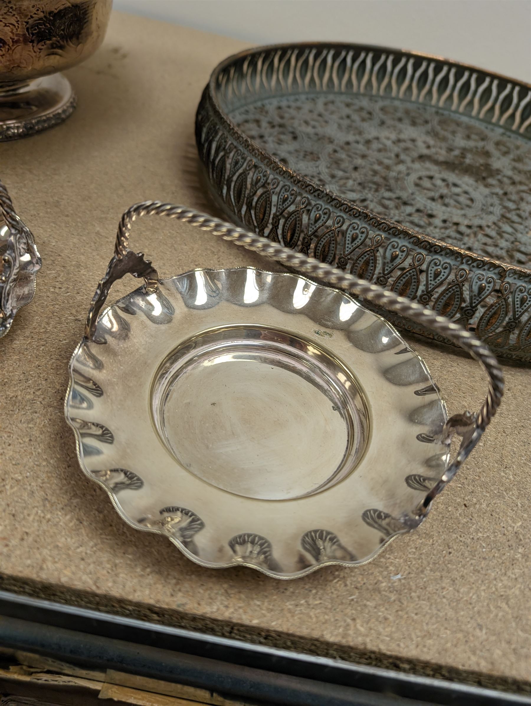 Silver plated bowl, with engraved decoration and cast rim, two silver plated baskets and a pierced tray