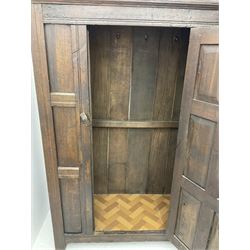 17th century and later oak hall cupboard, panelled front and sides with moulded frame, enclosed by single door with wrought metal hinges and handle, the interior fitted with hooks, on stile supports 