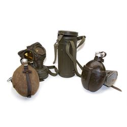 Two WWII German army canteen water bottles, together with German gas mask marked FE55 in a green fluted tin canister