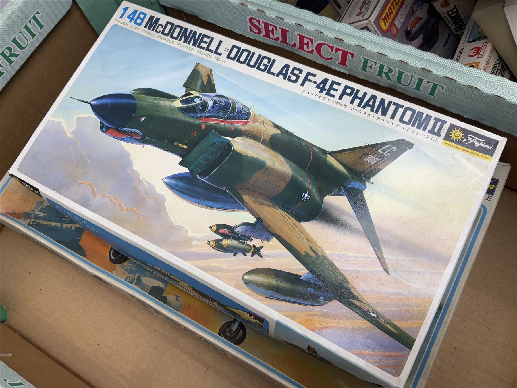 Twelve scale model kits, comprising ten model aircraft kits from Hasegawa, Nichimo, Fujimi and Matchbox, and two further Hasegawa 1:8 scale aircraft mounted machine gun kits, in two boxes 