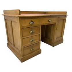 20th century oak desk, moulded rectangular top with raised back and inset leather writing surface, fitted with five drawers and single panelled cupboard, on moulded plinth base