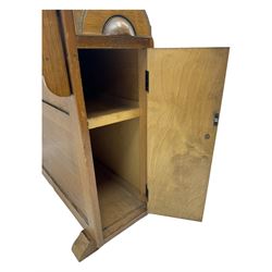 Early 20th century oak drop-leaf table, in the style of Harris Lebus, featuring rectangular top over central pedestal base, with two drawers and two cupboards, on gateleg supports