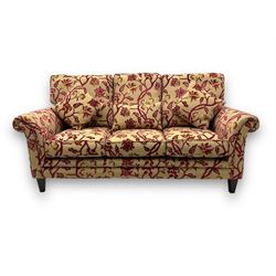 Contemporary upholstered three-seat sofa, scroll arms and loose cushions, embossed beige g...