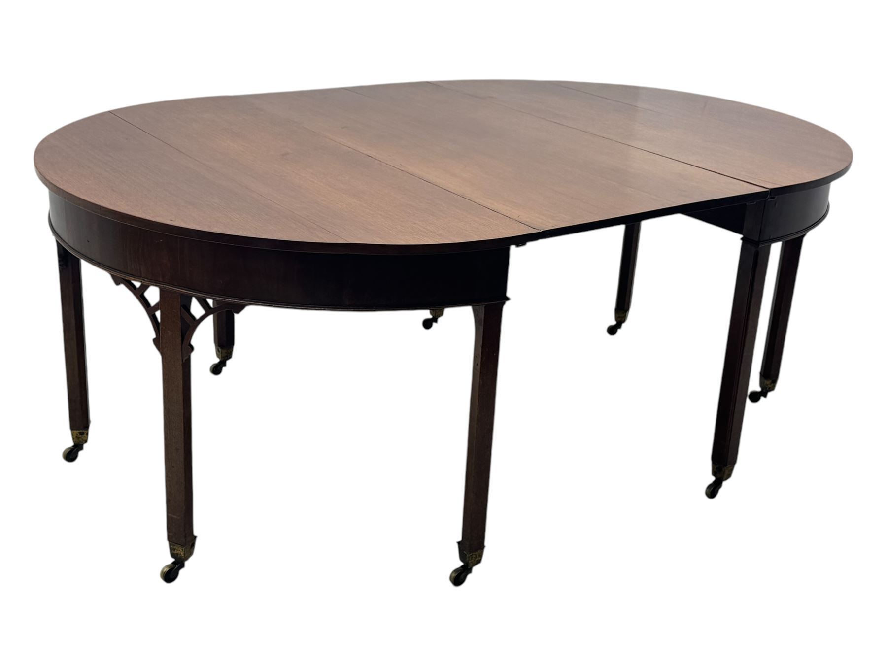 Early 19th century mahogany demi-lune extending dining table, two D-ends with central leaf insert, raised on eight square supports with arched spandrels terminating in brass castors