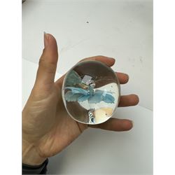 Two glass dump paperweights, with flower inclusions, together with four further glass paperweights