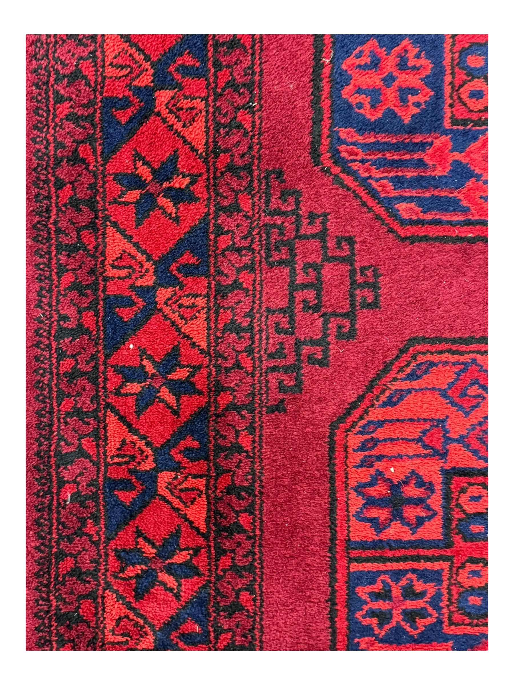 Persian Qashqai crimson ground rug, the field with central indigo and yellow medallion with geometric motifs, flanked by smaller medallions, border with repeating patterns (112cm x 200cm); Turkish Kazak light blue ground rug (109cm x 193cm); red ground runner with three octagonal medallions (69cm x 138cm)