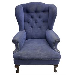 Early 20th century wingback armchair, upholstered in buttoned blue fabric, rolled and scrolled arms, on cabriole feet