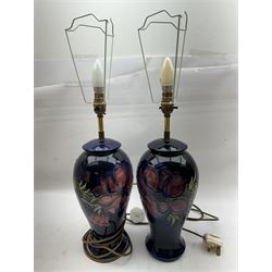 Pair of Moorcroft table lamps, in Anemone patter, upon a blue ground, with cream lampshades, H68