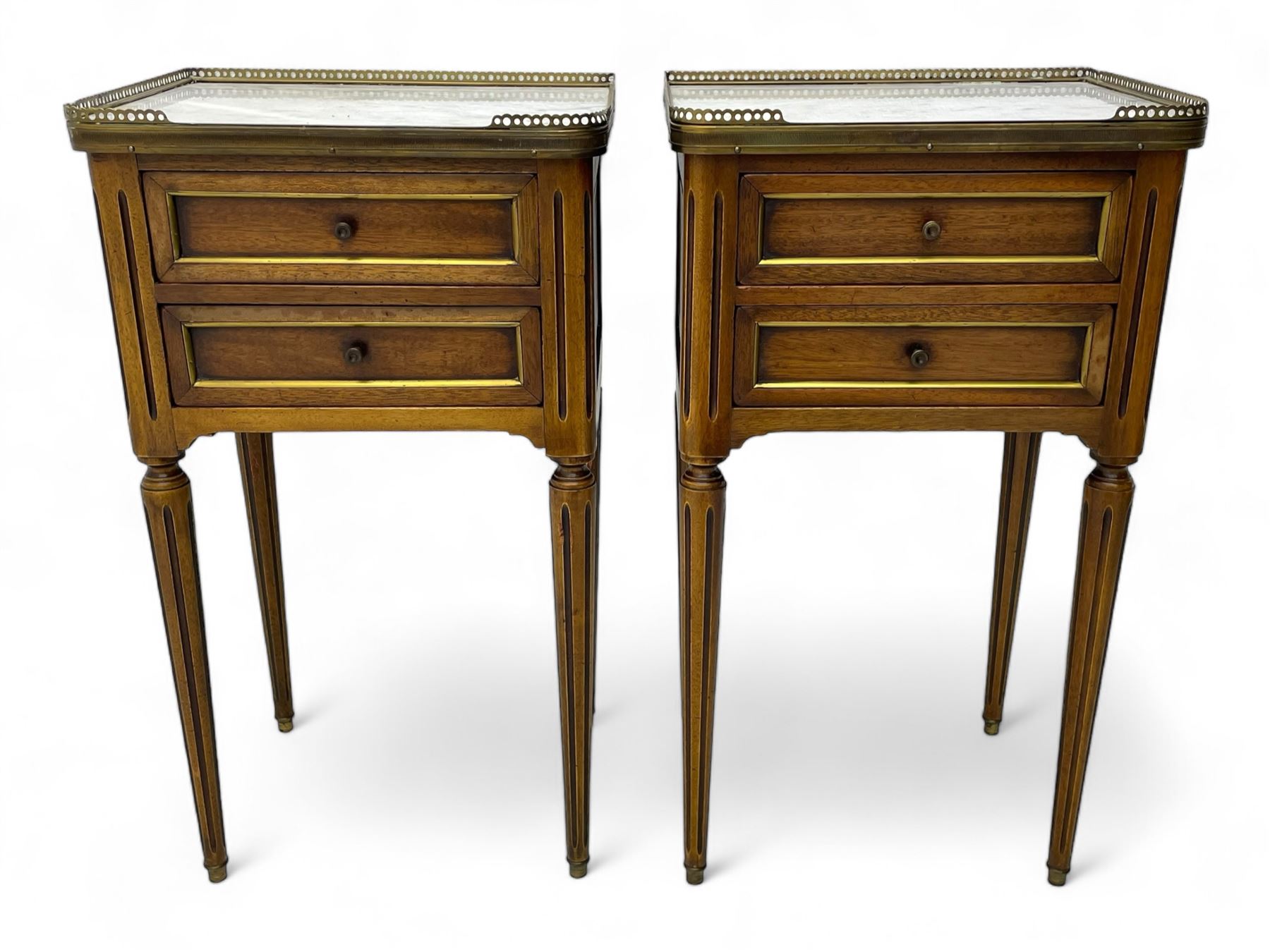 Pair of French design mahogany and marble bedside lamp tables, rectangular white marble top with raised brass gallery, fitted with two drawers, sunken facias with applied brass edging, panelled sides, on turned and fluted tapering supports 