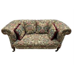 Mid-19th century walnut framed two-seat sofa, rolled arms over sprung seat, single drop-end action, raised on turned and fluted feet with brass cups and castors, upholstered by E & S Gott in traditional floral pattern fabric decorated with urns