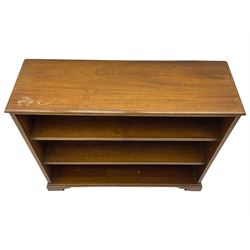 20th century mahogany open bookcase, fitted with two shelves, on bracket feet