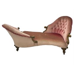 Victorian walnut framed tete-a-tete loveseat, scrolled arm terminals with moulded foliate decoration, buttoned backs and sprung seat upholstered in pale pink velvet, raised on cabriole supports with applied flower heads and scroll feet terminating to ceramic castors