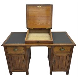 Edwardian pitch pine desk, rectangular top with writing slope flanked by inset leather writing surfaces, over twin pedestals each with shell cup handled drawer over cupboard, the left enclosing two shelves, the right enclosing sliding trays, on fluted straight supports