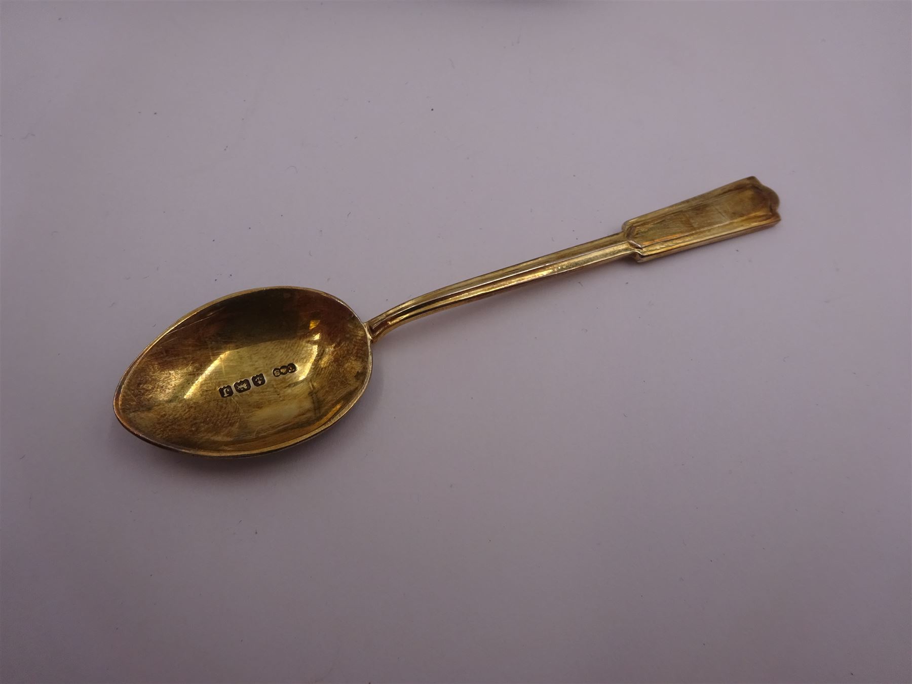 Set of six 1930s silver-gilt and enamel coffee spoons, the bowls and finials decorated verso in black and white enamel, hallmarked Turner & Simpson Ltd, Birmingham 1933, contained within fitted case