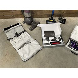 Dyson DC40 vacuum cleaner with various attachments, and a Vax cordless vacuum cleaner with single battery and charger