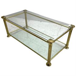 Gilt metal and bevelled glass two-tier coffee table, the faceted supports with Ionic Capitals