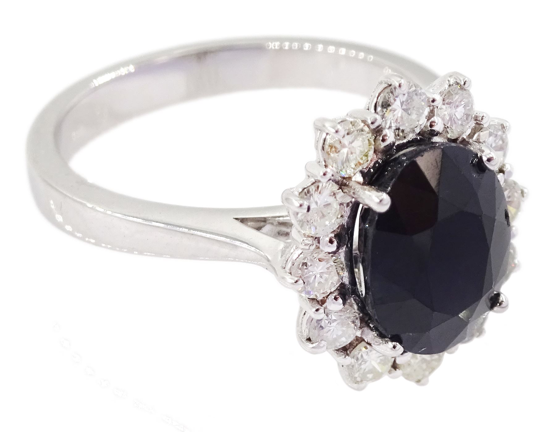 18ct white gold oval cut sapphire and round brilliant cut diamond cluster ring, hallmarked, sapphire approx 2.60 carat, total diamond weight approx 0.55 carat