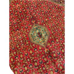 Persian Bijar red and blue ground rug, central panel decorated with tree of life and flower head motifs, decorated all-over with Herati motifs, triple band band border decorated with stylised plant motifs