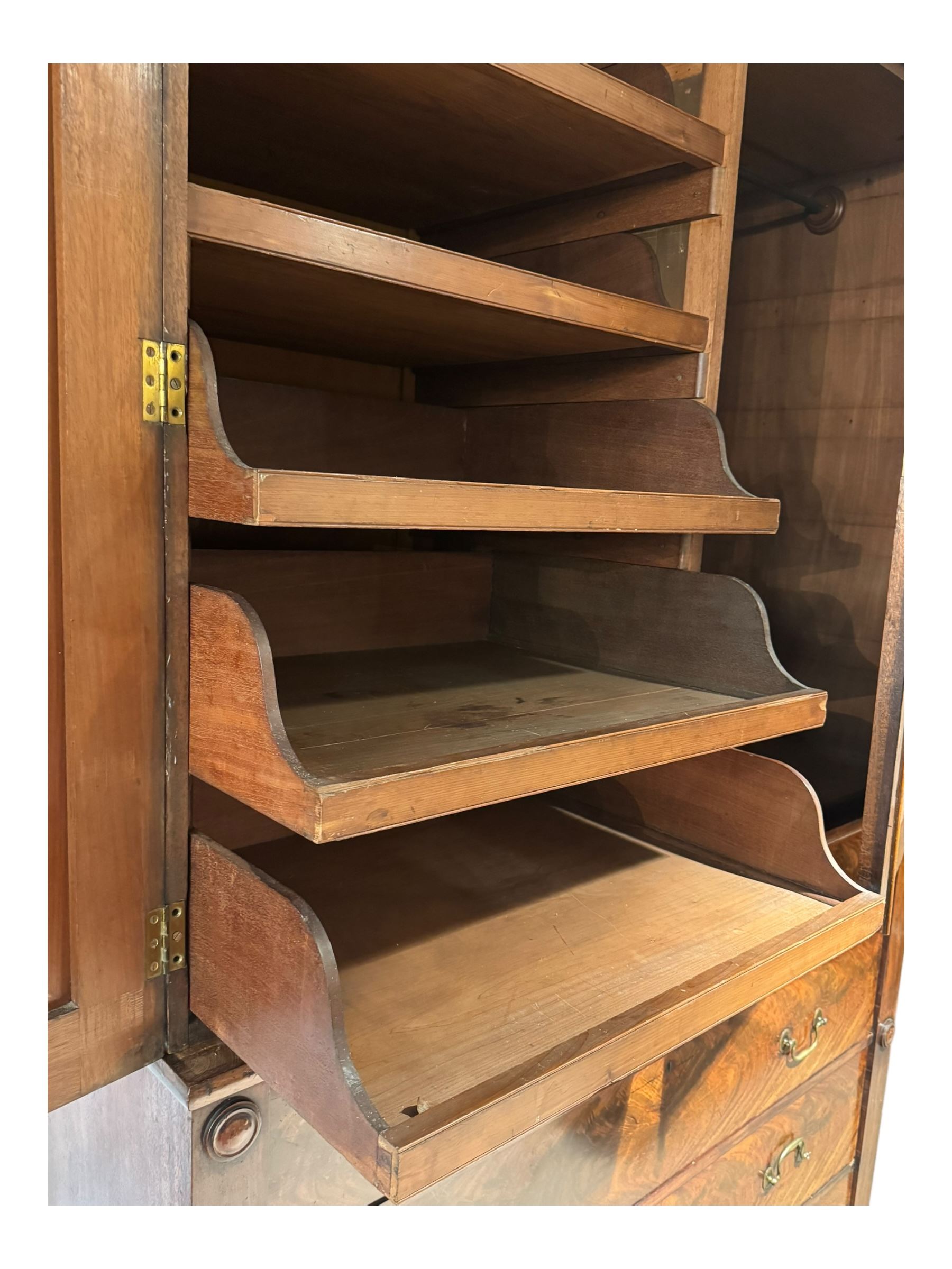 Victorian mahogany linen-press, moulded cornice over two figured panelled doors, the interior fitted with five slides and hanging rail, four long drawers below 